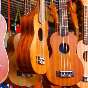 Row of colorful ukulele hanging at the Maui Ukulele Festival