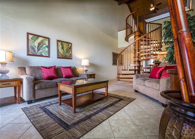 Living room with spiral staircase in the background