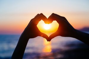 Hands shaping a heart at the Maui sunset | Romantic activities on Maui