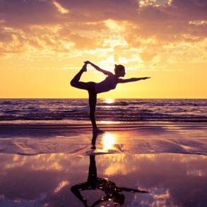Woman enjoying a Maui yoga retreat on the beachga