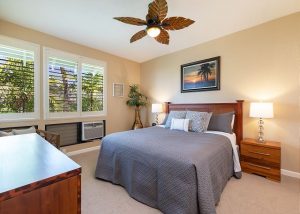 Condo bedroom with window view of nature