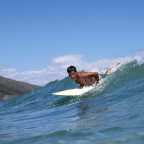 Boy riding wave on Maui