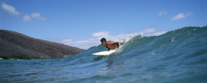 Boy riding wave on Maui