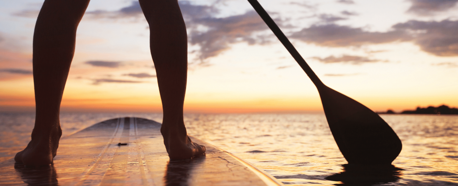 Woman paddleboarding on the ocean