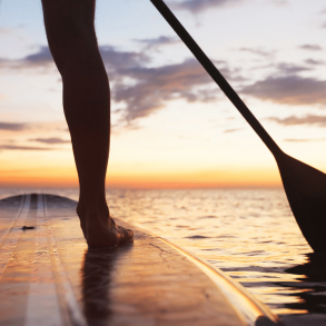 Woman paddleboarding on the ocean