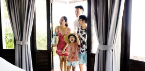 Asian family walking into bright vacation rental