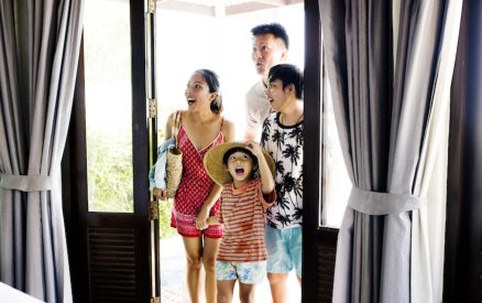 Asian family walking into bright vacation rental
