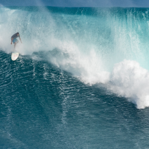 surfer riding big wave at jaws surf break