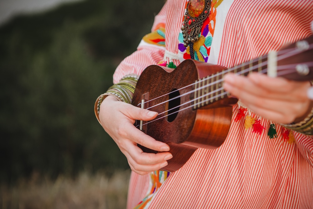 Close up hands playing Hawaiian ukelele